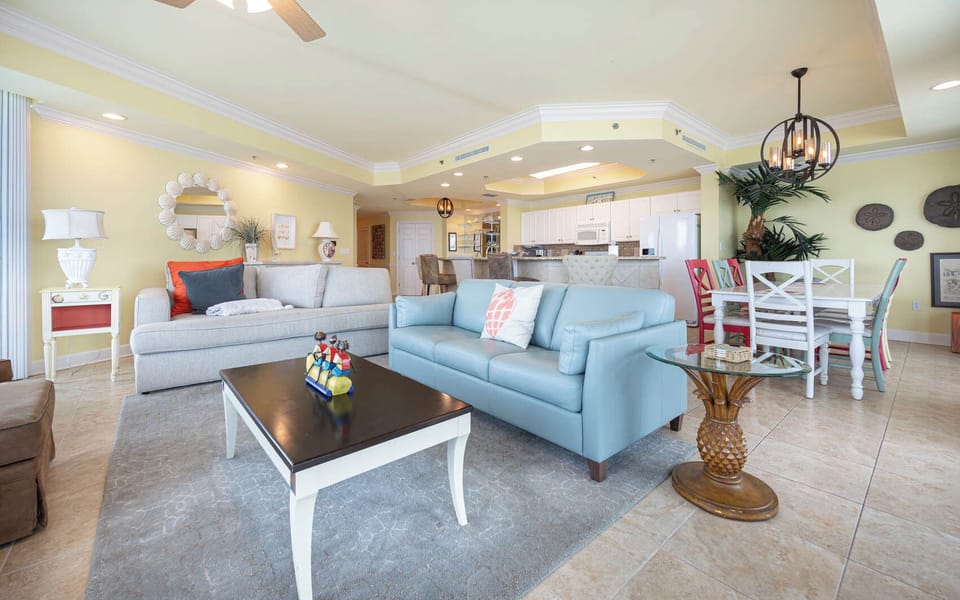 Relax in the inviting living area featuring a sofa with queen sleeper, a stylish coffee table, and views of the open kitchen