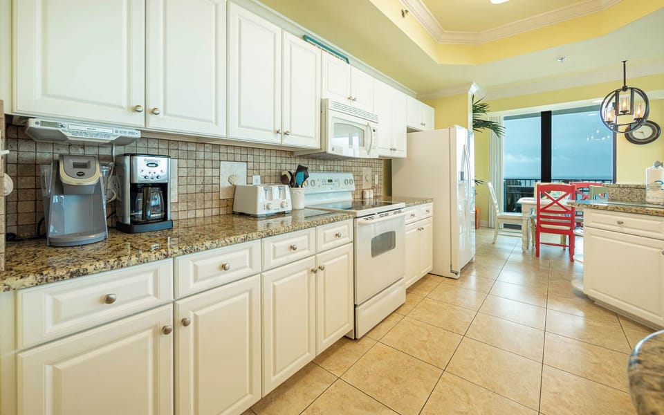 Prepare meals in the spacious kitchen featuring granite countertops and stylish coffee corner