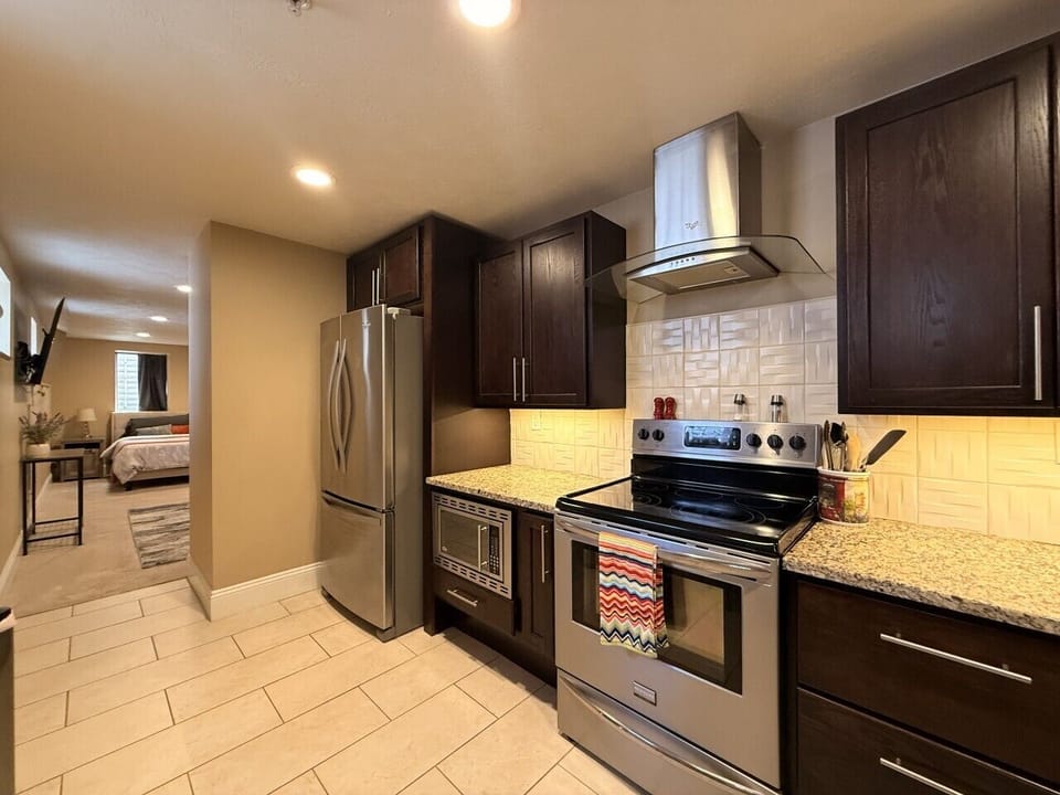 The stainless steel appliances add a touch of sophistication to the contemporary design, while providing all the modern conveniences you need to prepare your meals with ease. The spacious countertops offer ample room for meal preparation, and the well-equ