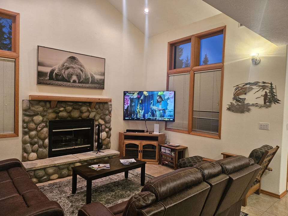 Cozy living room with stone fireplace and vaulted ceilings