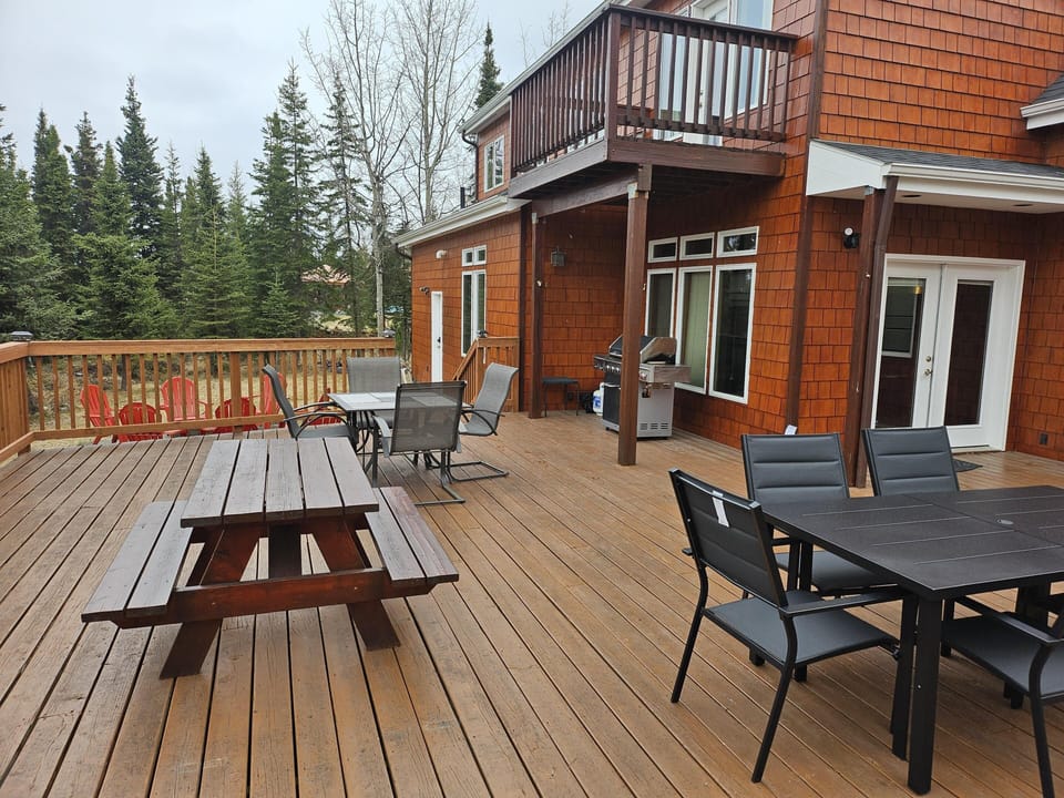 Spacious outdoor deck with dining and picnic seating for gatherings