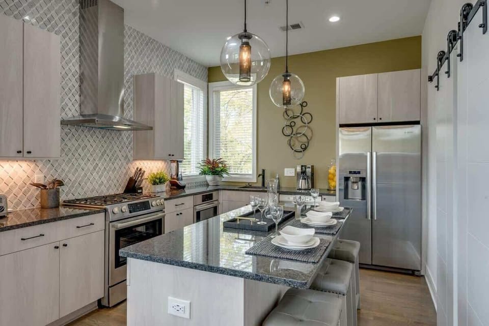 The heart of the home—a fully equipped kitchen with a massive island for group breakfasts and social hour.