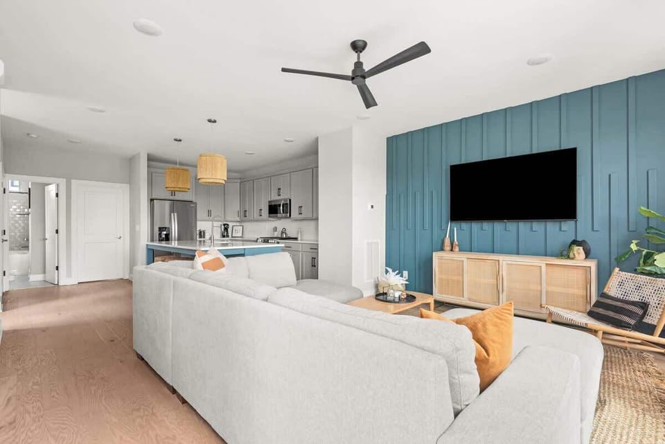 Gather together: Open-concept living area featuring a massive 70-inch Smart TV with complimentary cable and high-speed Wi-Fi.
