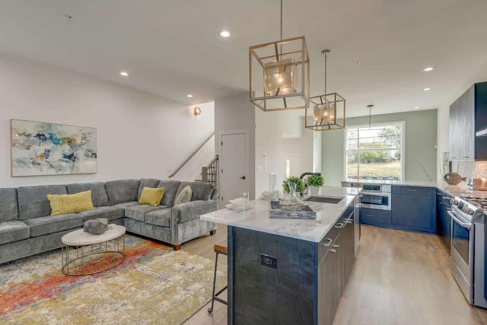 Spacious open-concept living area with a custom designer sectional—plenty of room for the whole group to gather.