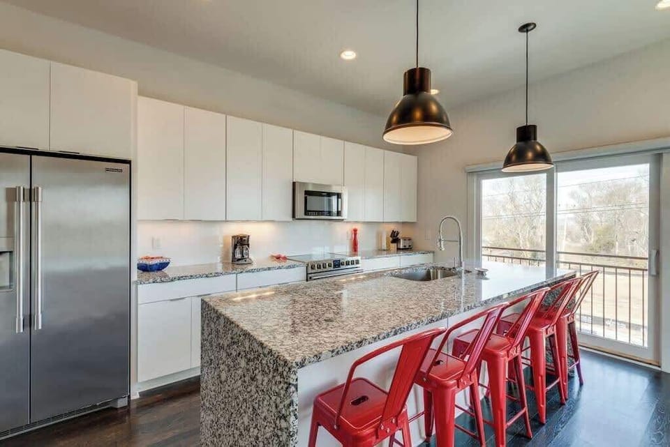 Modern chef’s kitchen—fully equipped for group meals before heading out to the Honky Tonks, just minutes away.