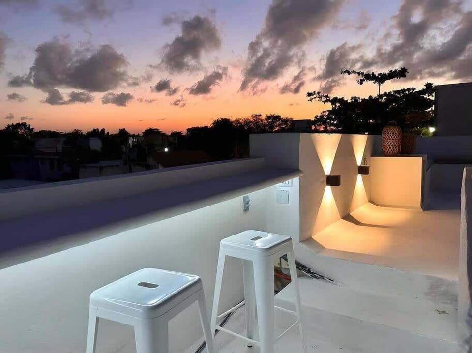 Rooftop terrace with string lights at dusk