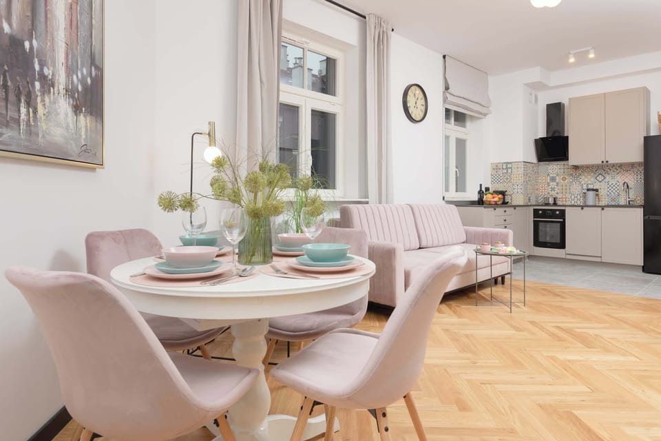 Functional dining area in pastel pink hues.