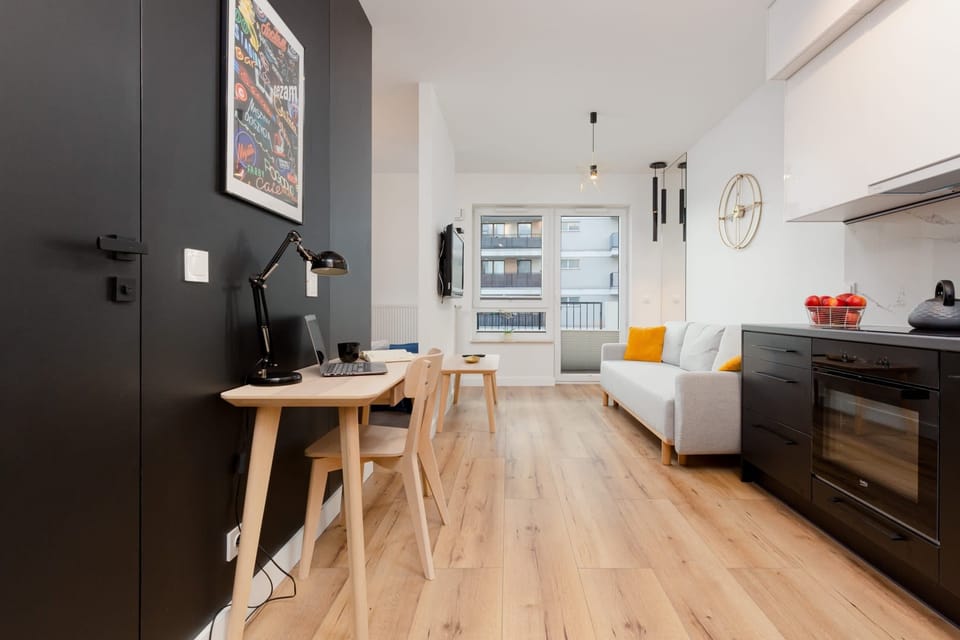 A modern kitchenette equipped with essential appliances, including a stove and sink.
