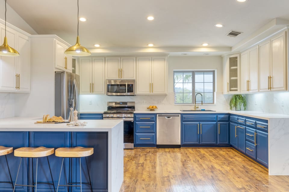 Spacious kitchen features an open layout with modern appliances and barstool seating.