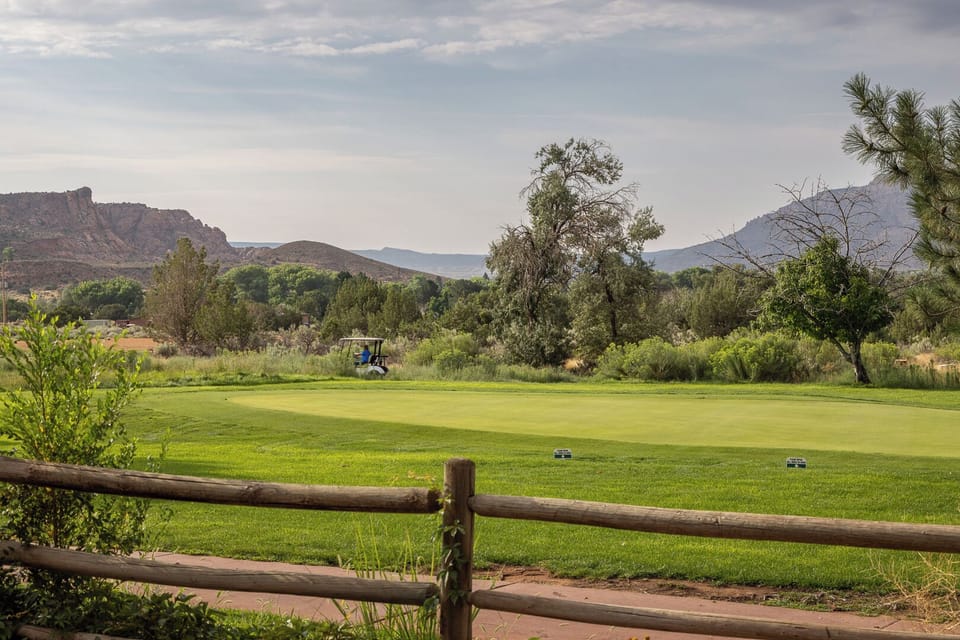 Famous Moab Rim in the distance. Mature trees and vegetation surrounding the unit.