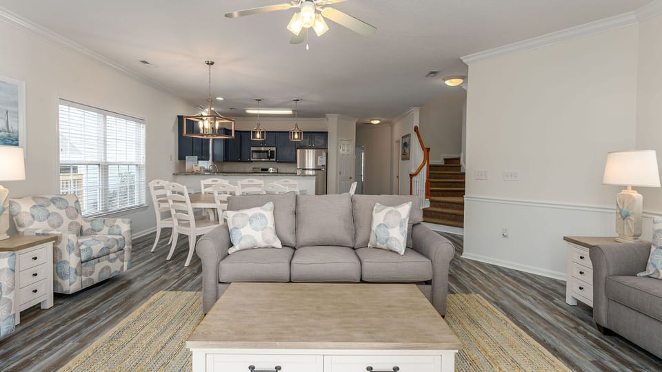 Relax in this beautifully appointed open-concept living space with comfortable seating and modern kitchen where your group can gather.