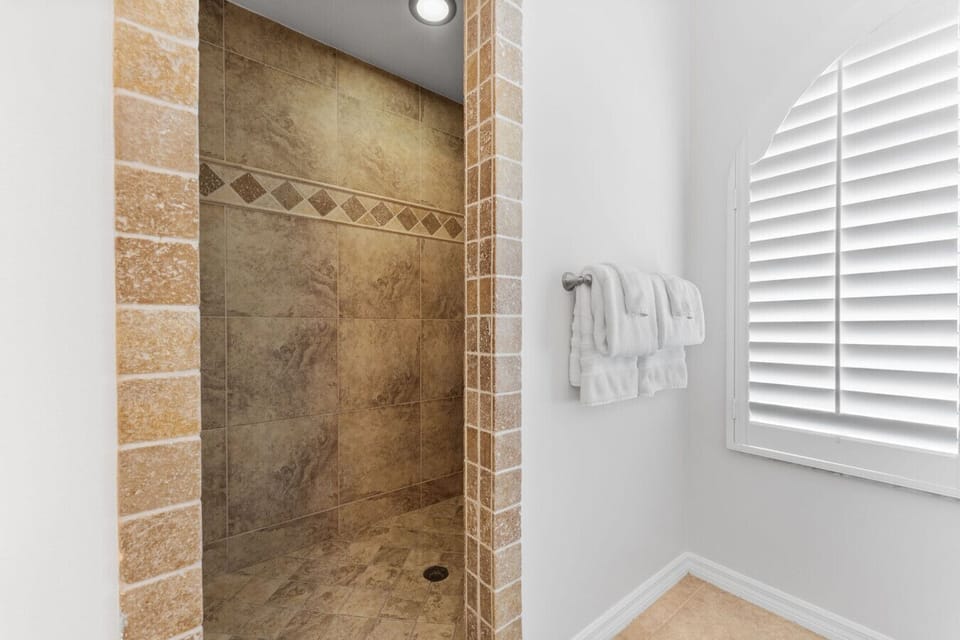 Unwind with a relaxing rinse in this spacious, tiled walk-in shower