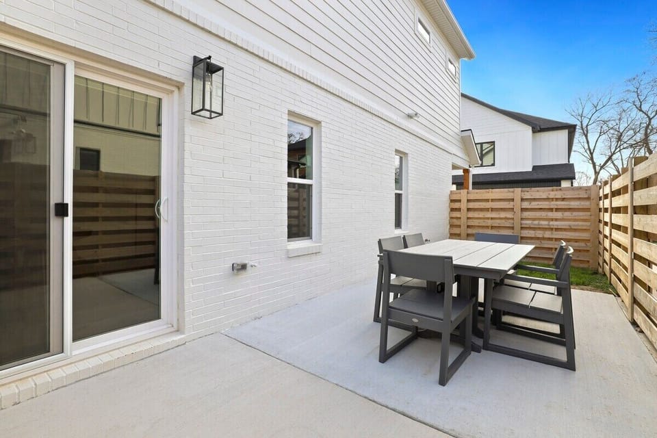Outside, on the side patio there is a private outdoor dining area and gas grill.
