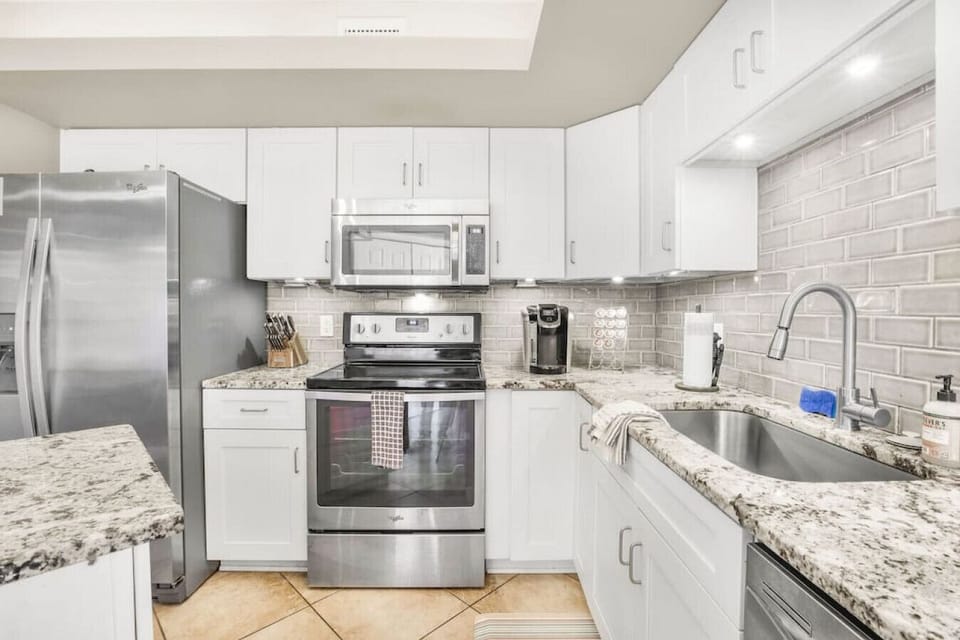 Kitchen and Sink area with island, k-kup coffee machine, and more