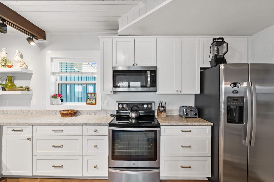 Your bright, fully equipped kitchen makes meal prep a breeze with modern stainless steel appliances, granite counters, and plenty of cabinet space to feel right at home.