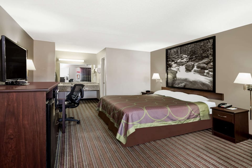 Desk, laptop workspace, blackout drapes, iron/ironing board