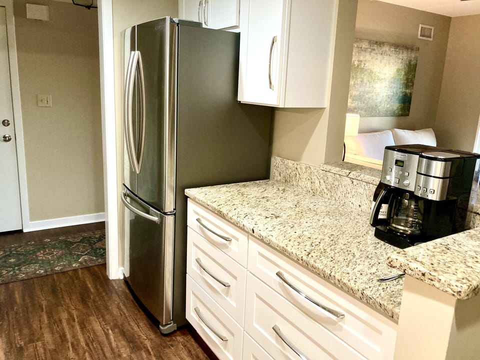 Coffee bar/prep area overlooks the den and dining area.