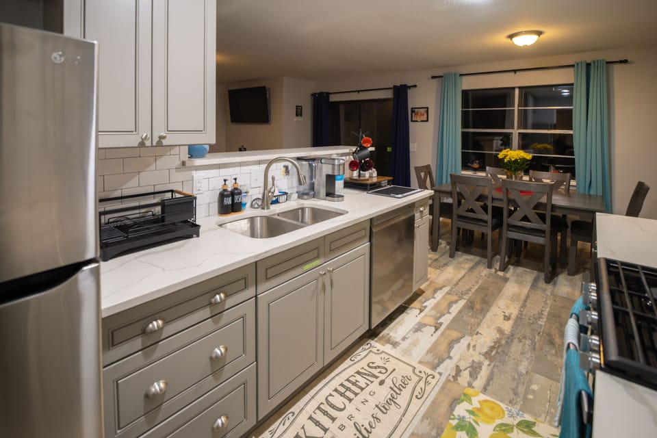 Fully renovated kitchen with dishwasher and fully-stocked coffee station.