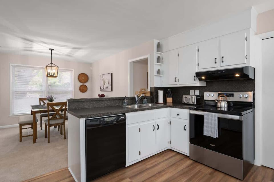 Fully equipped kitchen with all essential appliances and a spacious dining table that seats six—perfect for home-cooked meals and gathering with family or friends.