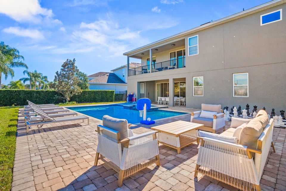 Grab a seat in the cozy patio lounge with a view of the pool and palm trees swaying in the breeze.