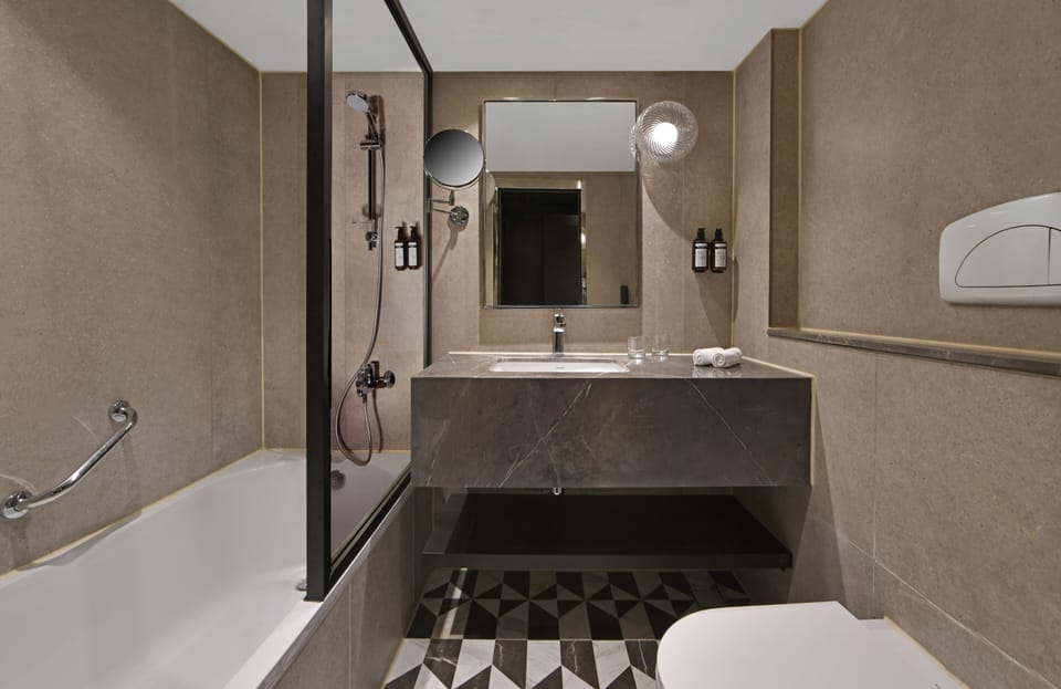 Bathtub, hair dryer, bathrobes, slippers