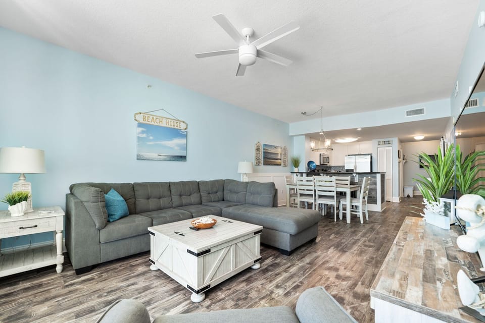 Relax in your bright, beach-themed living space with comfy sectional seating and coastal decor that makes every day feel like vacation.