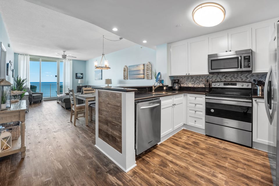 Your fully equipped kitchen opens to ocean views, perfect for morning coffee while watching waves roll in.