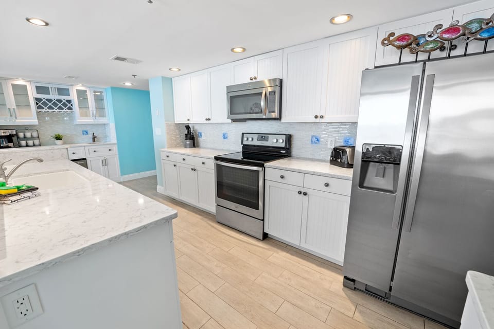 Your bright, modern kitchen features stainless steel appliances and spacious counters for preparing delicious meals during your stay.