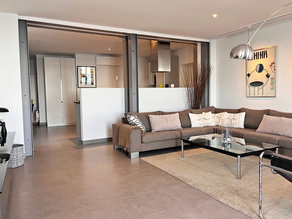 Living room with kitchen in the background.