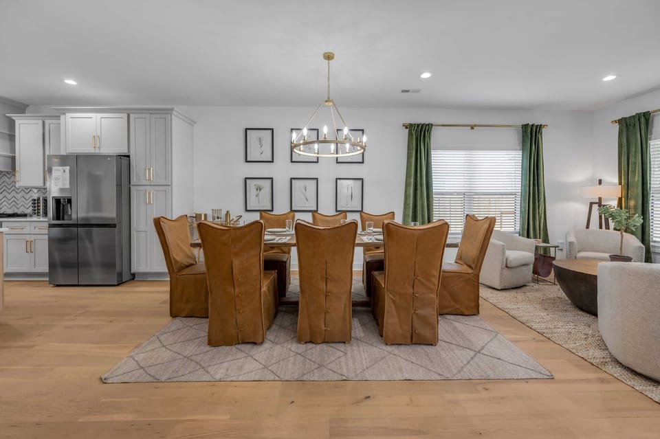 Dine in style in our open-concept dining room. The centerpiece is an expandable table, perfect for accommodating intimate gatherings or large feasts, creating a versatile and inviting space.