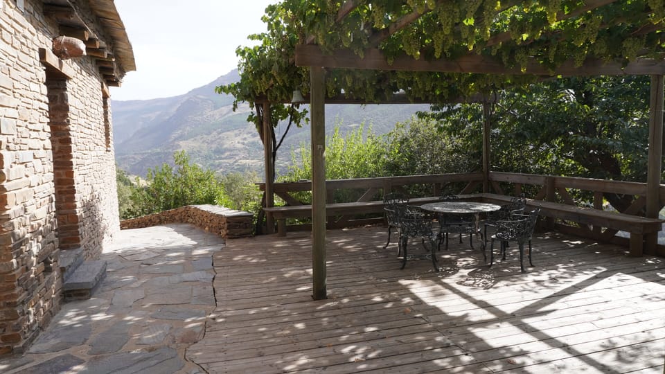 Covered patio with table and chairs for guests of Walnut exclusively.