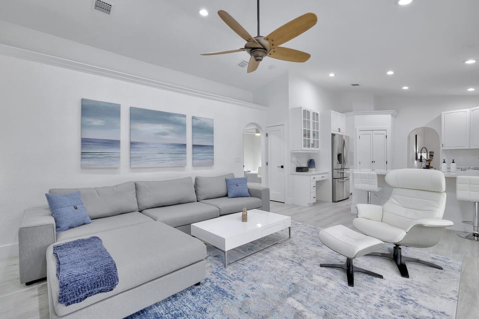 Spacious sofa and captains chair to overlook the pool and TV.