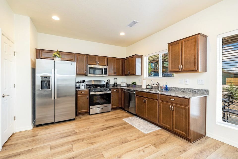Well stocked kitchen including gas stove, dishwasher, refrigerator with ice maker, air fryer, blender, and more. All you need to cook and enjoy a meal.