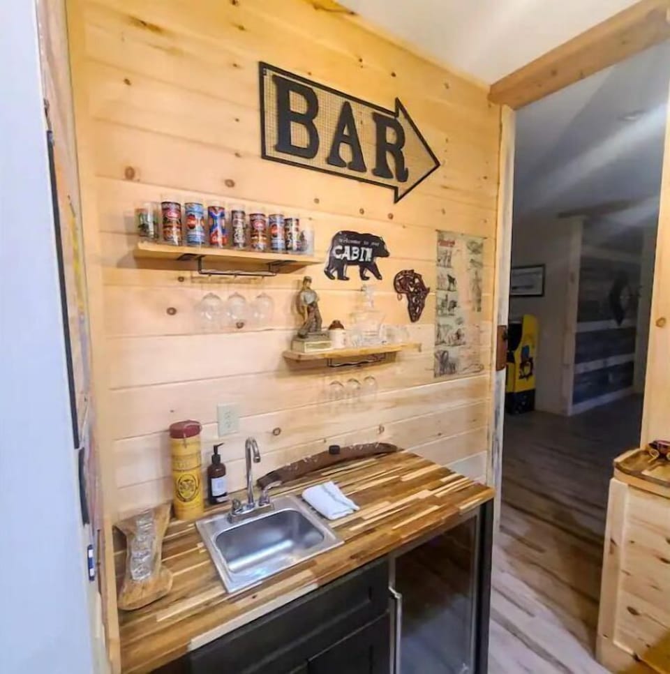 Basement bar area with sink and beverage refrigerator
