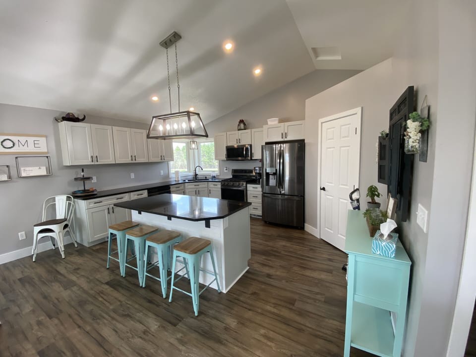 Kitchen area with pantry, dishwasher, oven and full size fridge