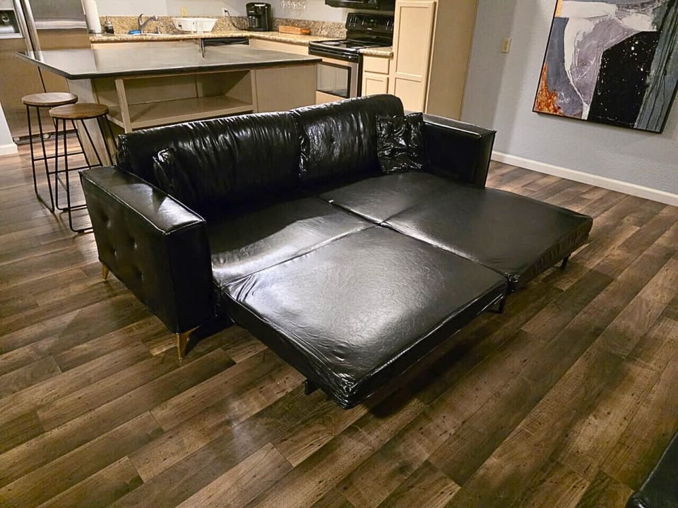 Leather couch with king sofa bed sleeps two.