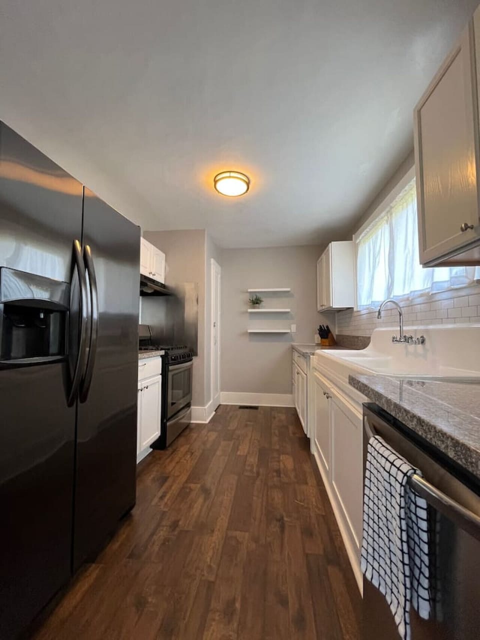 Fully equipped kitchen includes side-by-side refrigerator with ice maker and in-door water dispenser.