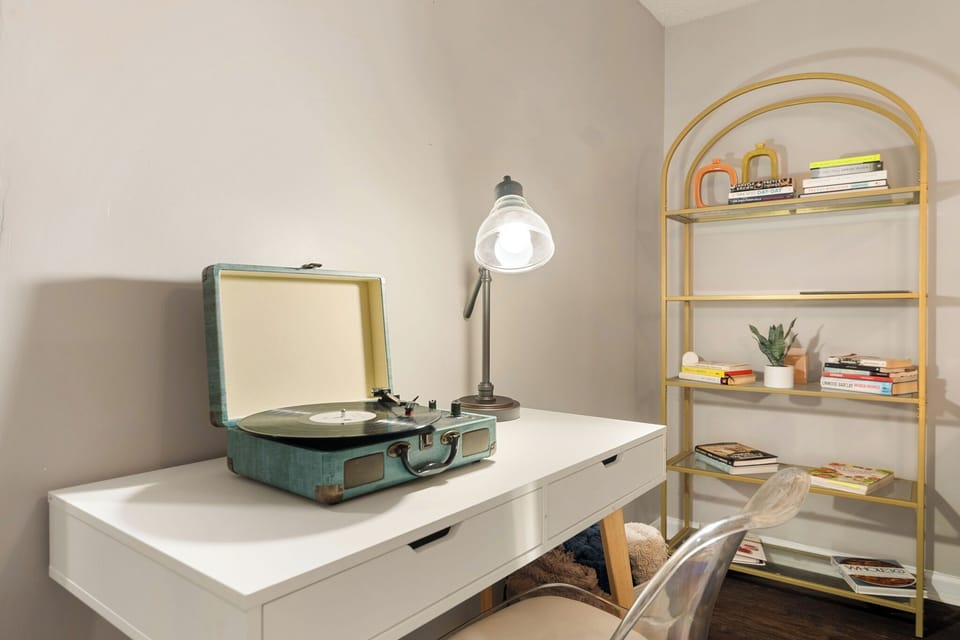 An Inviting bookshelf, table, and comfortable chairs, perfect for reading.