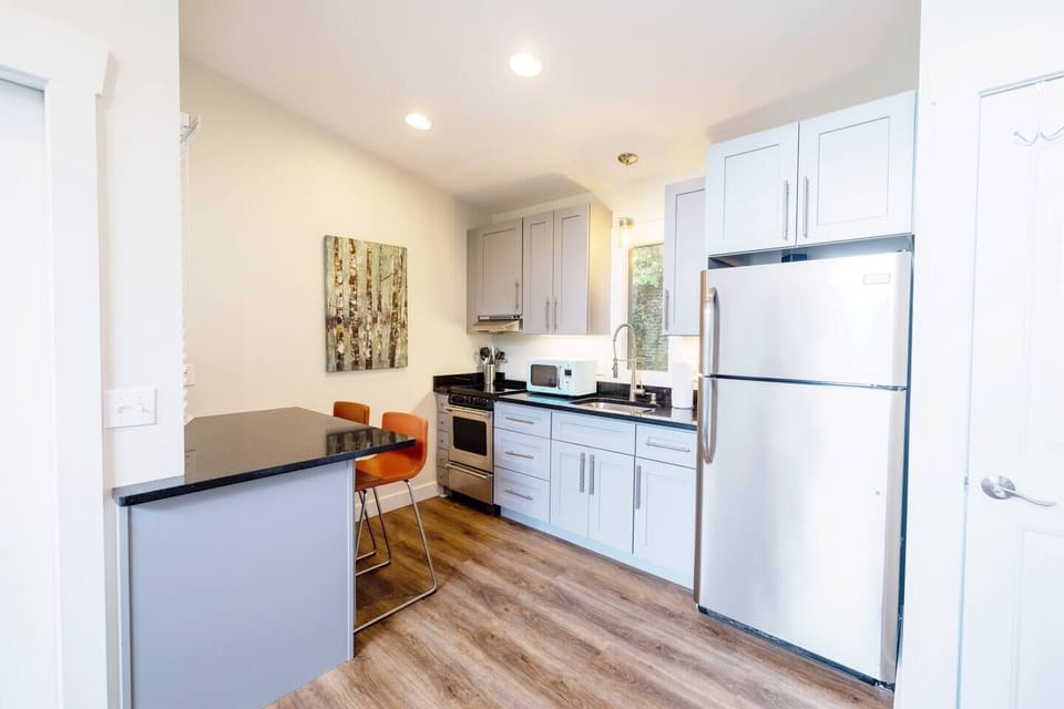 Full kitchen with microwave and drip coffee maker