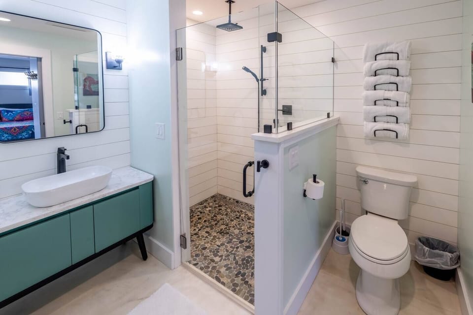 Walk-In Shower with Marine Grade Plank Walls and Pebble Floor