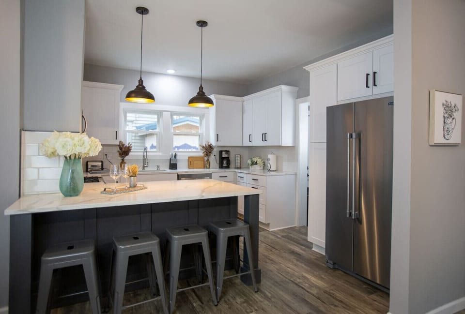 Open kitchen with quartz countertops and an island