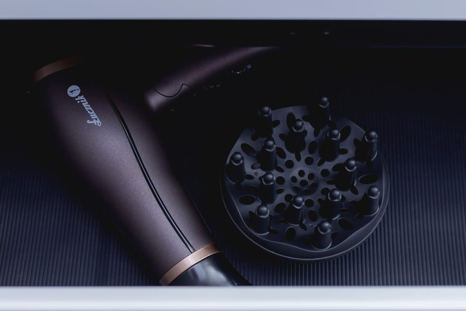 A close-up of a modern hairdryer, adding a thoughtful detail for guest convenience.





