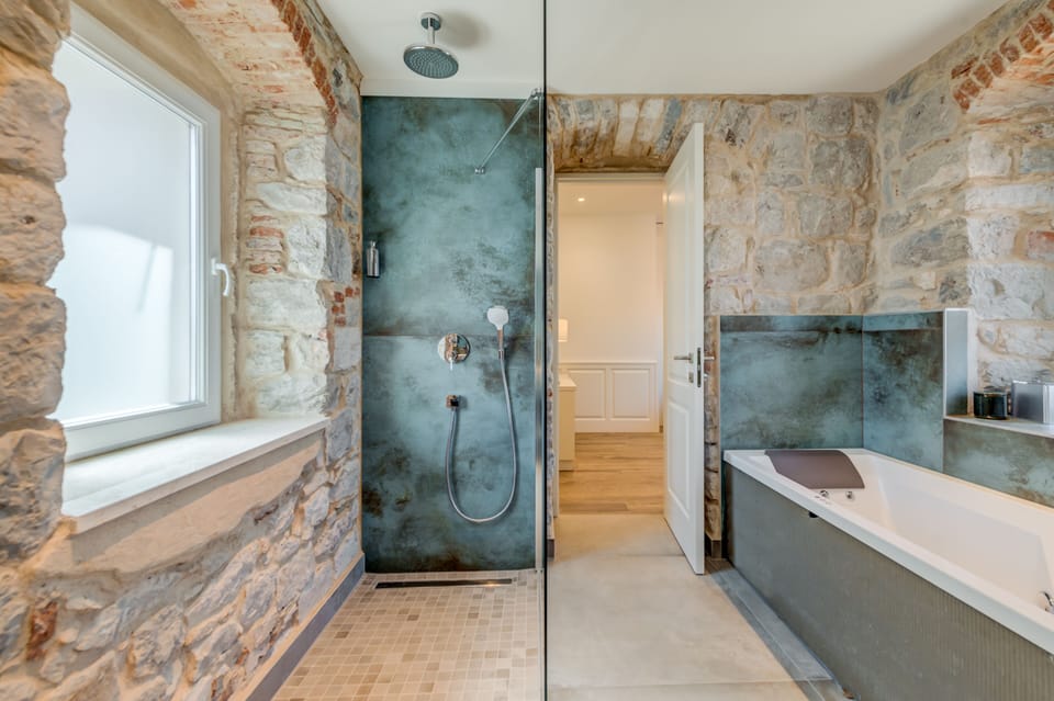 Deluxe Double Room | Bathroom | Shower, rainfall showerhead, hair dryer, heated floors