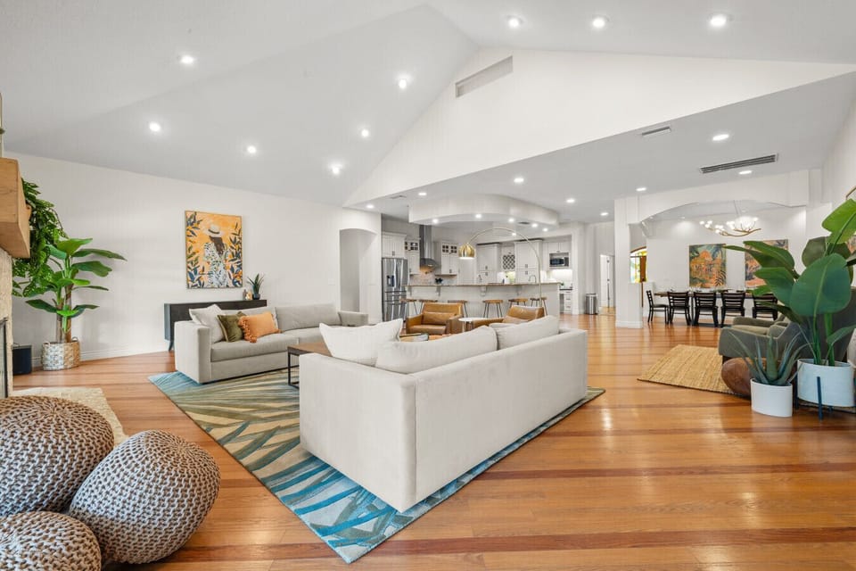 Large open living room with seating for 14, pool access and 65` TV