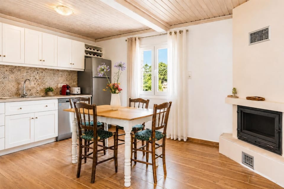 Fully equipped kitchen, and indoor dining area with a fireplace