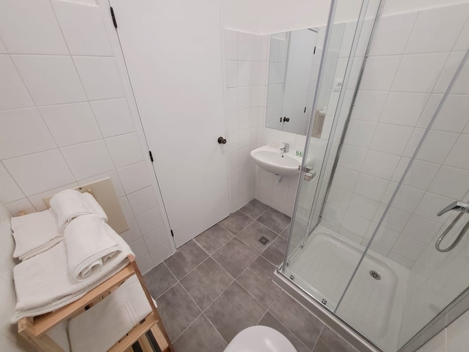 Shower, rainfall showerhead, hair dryer, towels