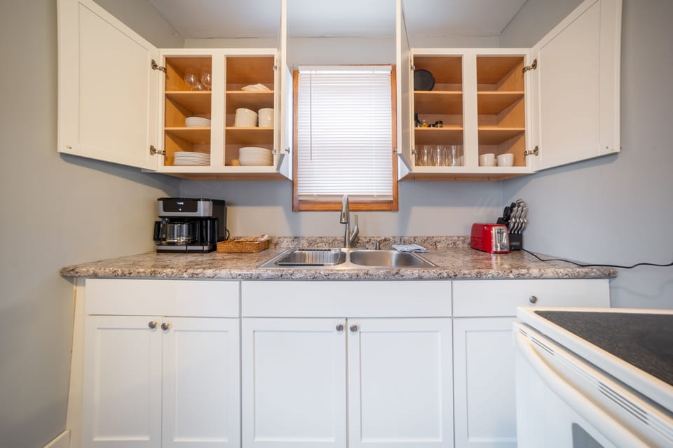 coffee maker (pods and grounds) with sweeteners and creamers.