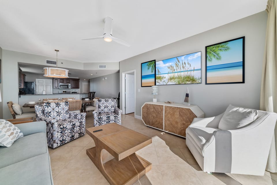 A comfortable living room with ample seating, flowing into a dining area, ideal for everyday living and gatherings.