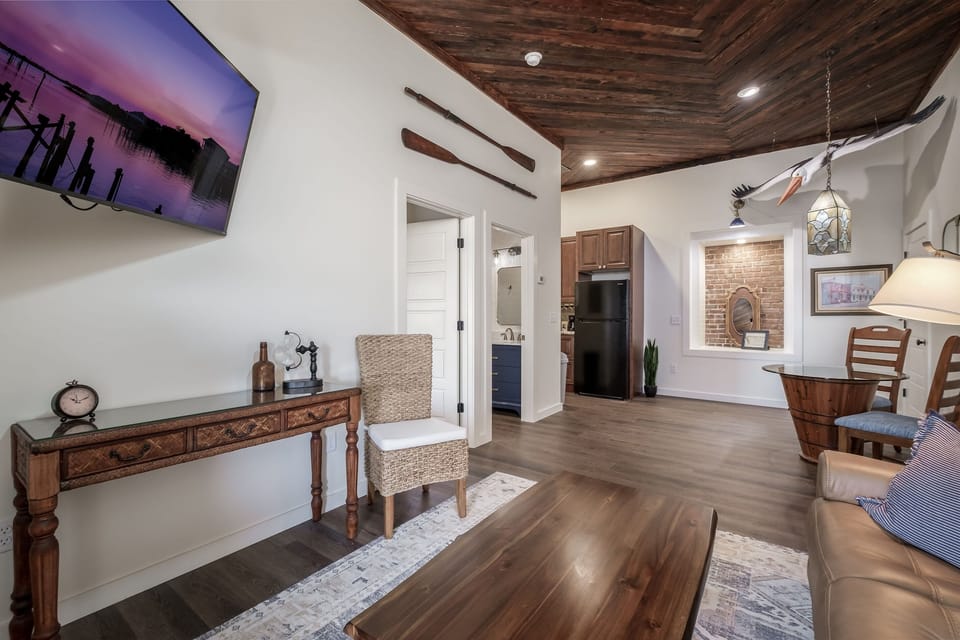 Living and dinette area. Living Space features gorgeous refinished and repurposed wood ceilings. 