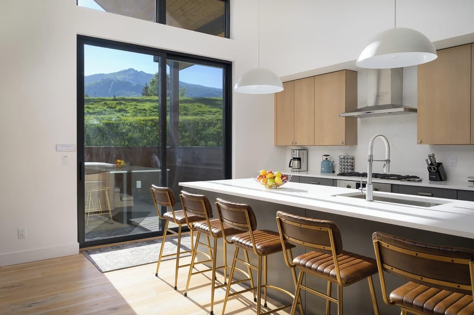 Additional seating for five at the breakfast bar and deck access